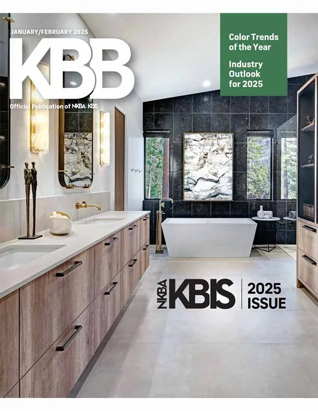 The cover of a magazine titled 'KBB', January/February 2025 issue, featuring a modern bathroom with a white bathtub, black tiled walls, a large mirror, wooden vanity, and decorative lighting.
