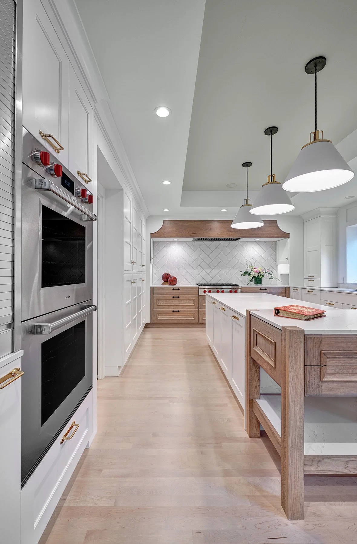 Home remodel, warm contemporary kitchen, hickory and white cabinetry, Sub-Zero Wolf appliances, open legwork island endcap