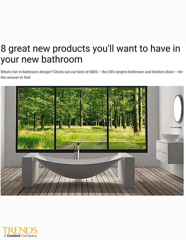 Modern bathroom with a freestanding bathtub in front of a large window showing a green forest, with a sink and mirror on the right side.