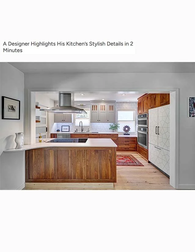 A modern kitchen with a wooden island, white countertops, gray cabinets, and stainless steel appliances.