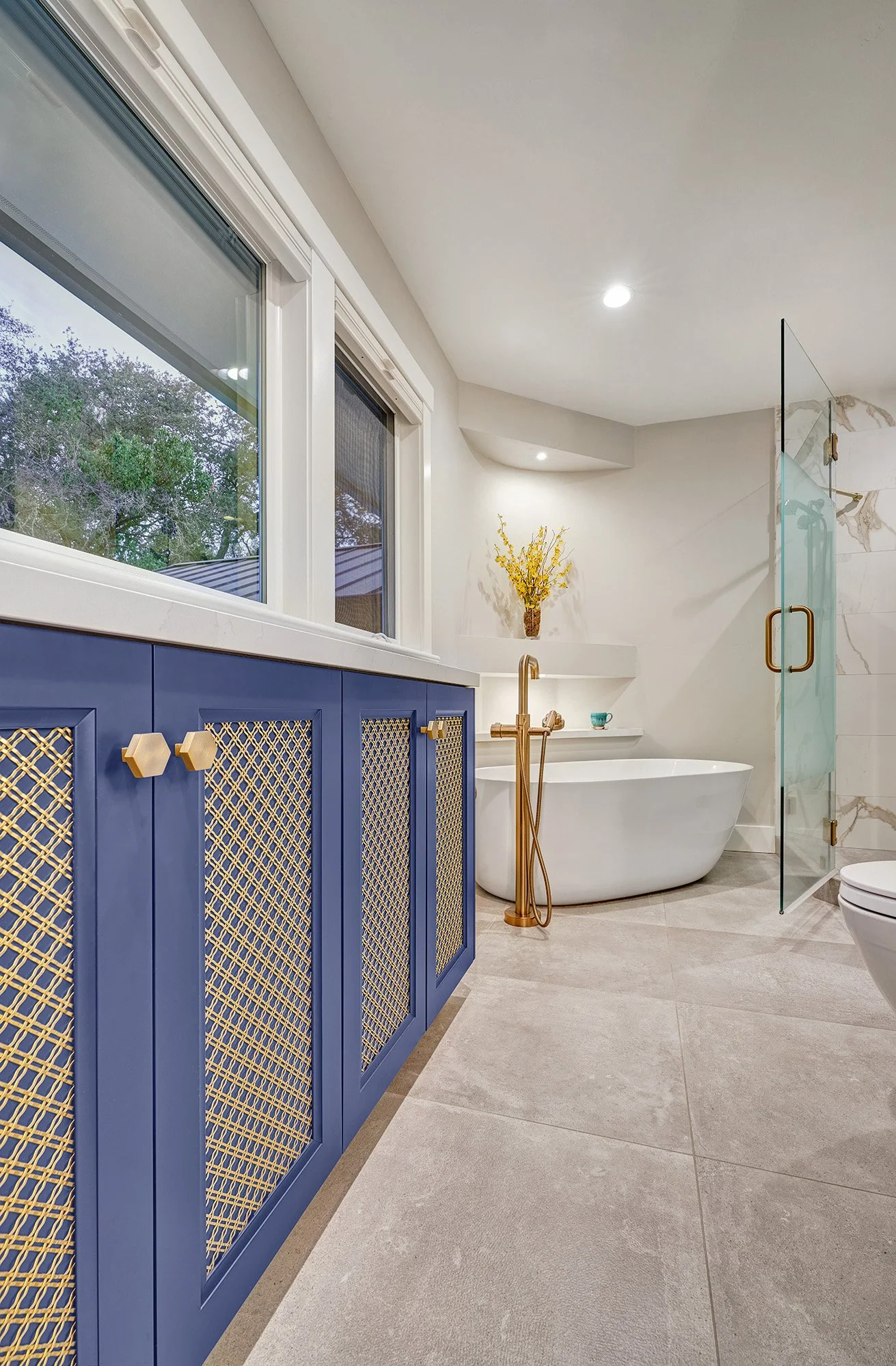 Whole home remodel, modern farmhouse, farmhouse industrial primary bathroom, blue cabinetry, metal mesh, freestanding tub