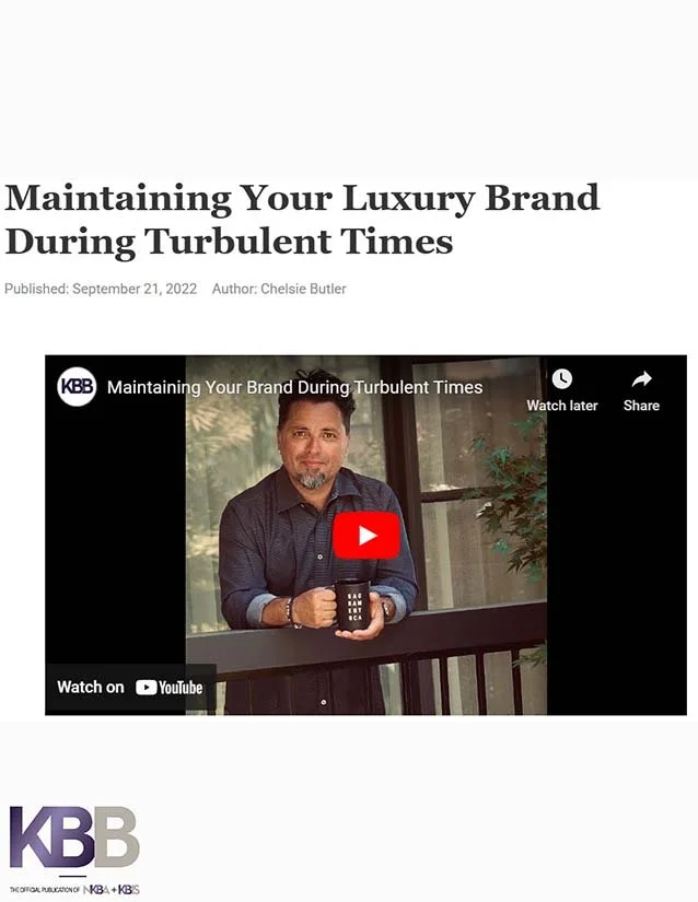 Article titled "Maintaining Your Luxury Brand During Turbulent Times" with publish date September 21, 2022, authored by Chelsie Butler. Below the title, there is a video thumbnail showing a man with a beard in a dark shirt, holding a mug, standing on
