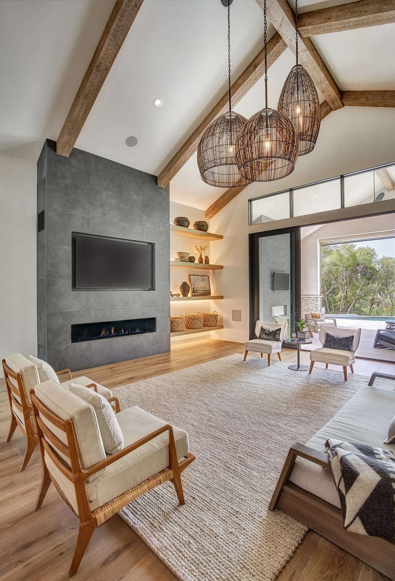Warm modern new construction home, linear fireplace, wood beams, backlit cabinet shelving