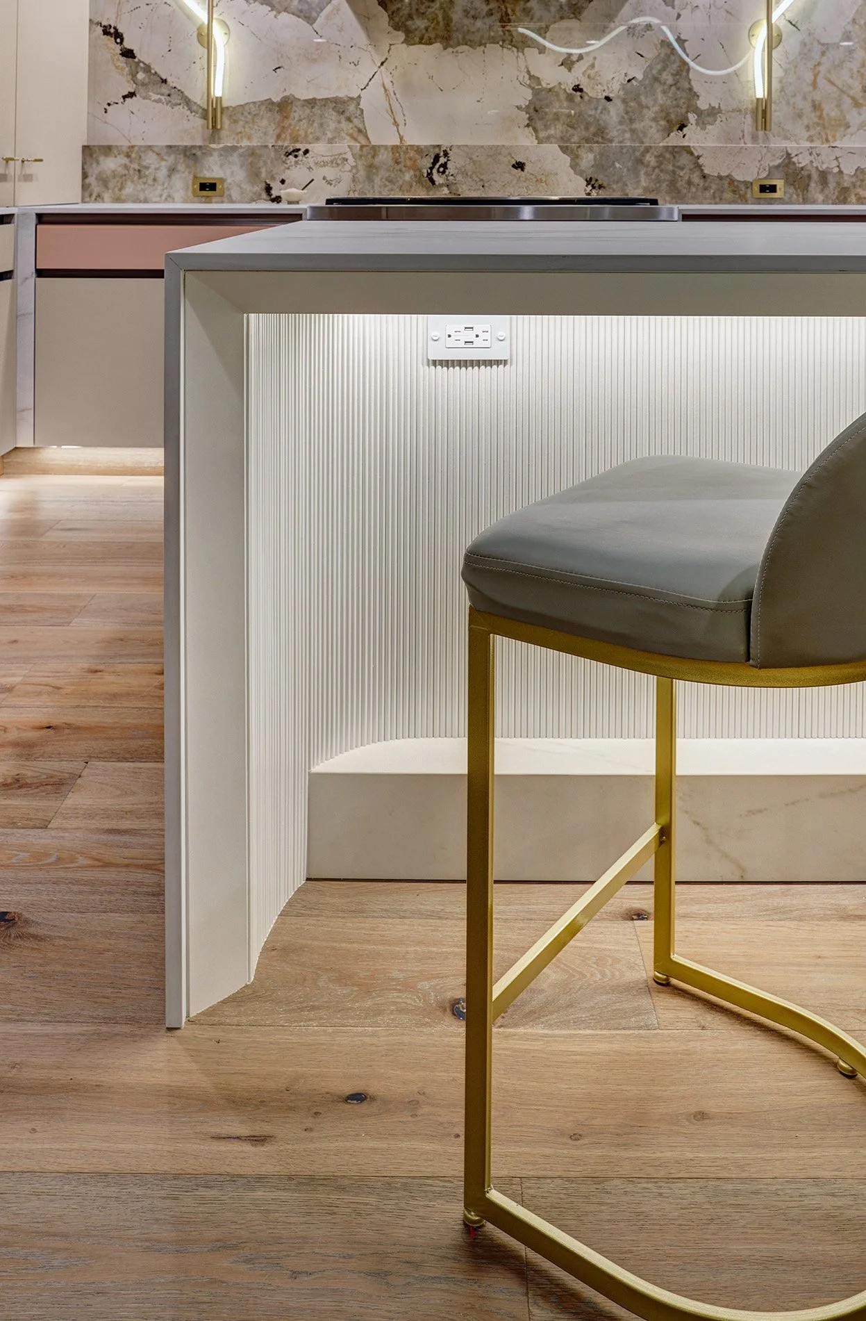 Modern kitchen remodel, blush glass drawer fronts and hood, custom ribbed paneling, curved and beveled island knee space
