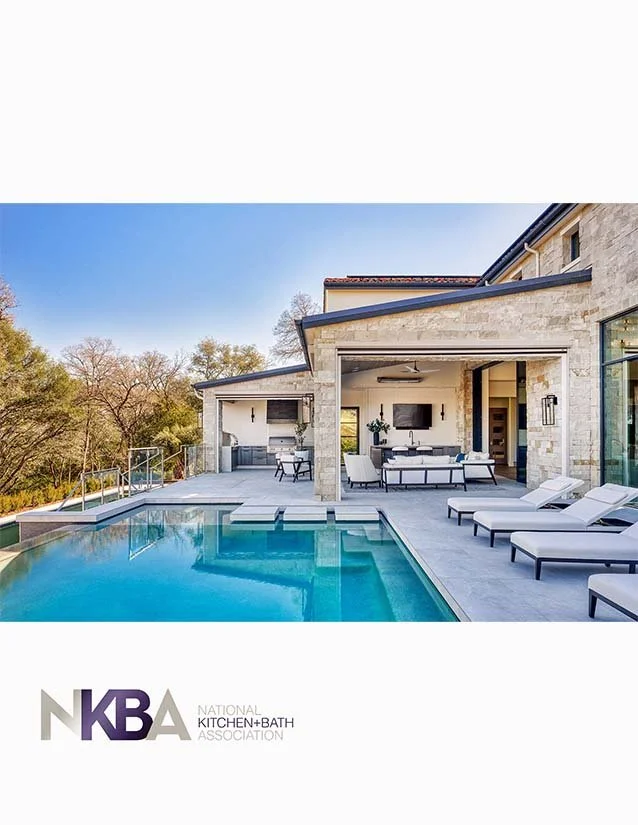 Exterior view of a modern house with a swimming pool, outdoor lounge area, and patio furniture in a backyard with trees and blue sky.