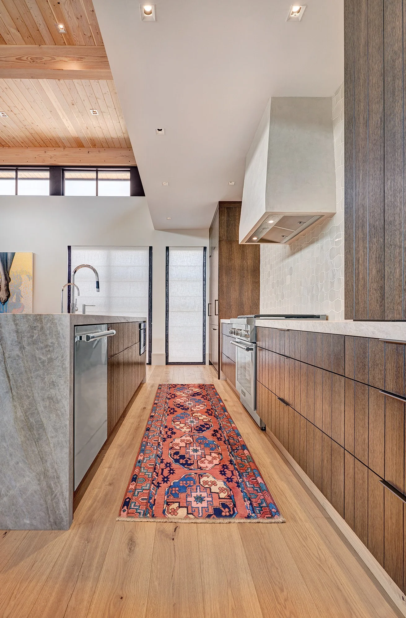 Warm contemporary new construction home, kerf cut kitchen cabinet, plaster hood, tile splash