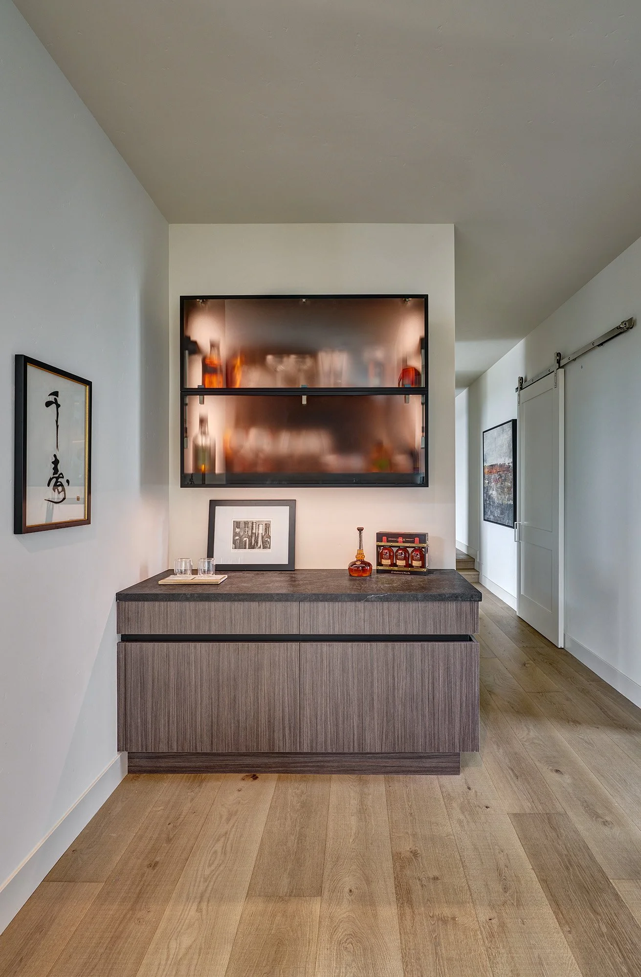 Modern new construction home, European laminate cabinetry, bar with channel hardware and glass fold up internally lit wall cabinet