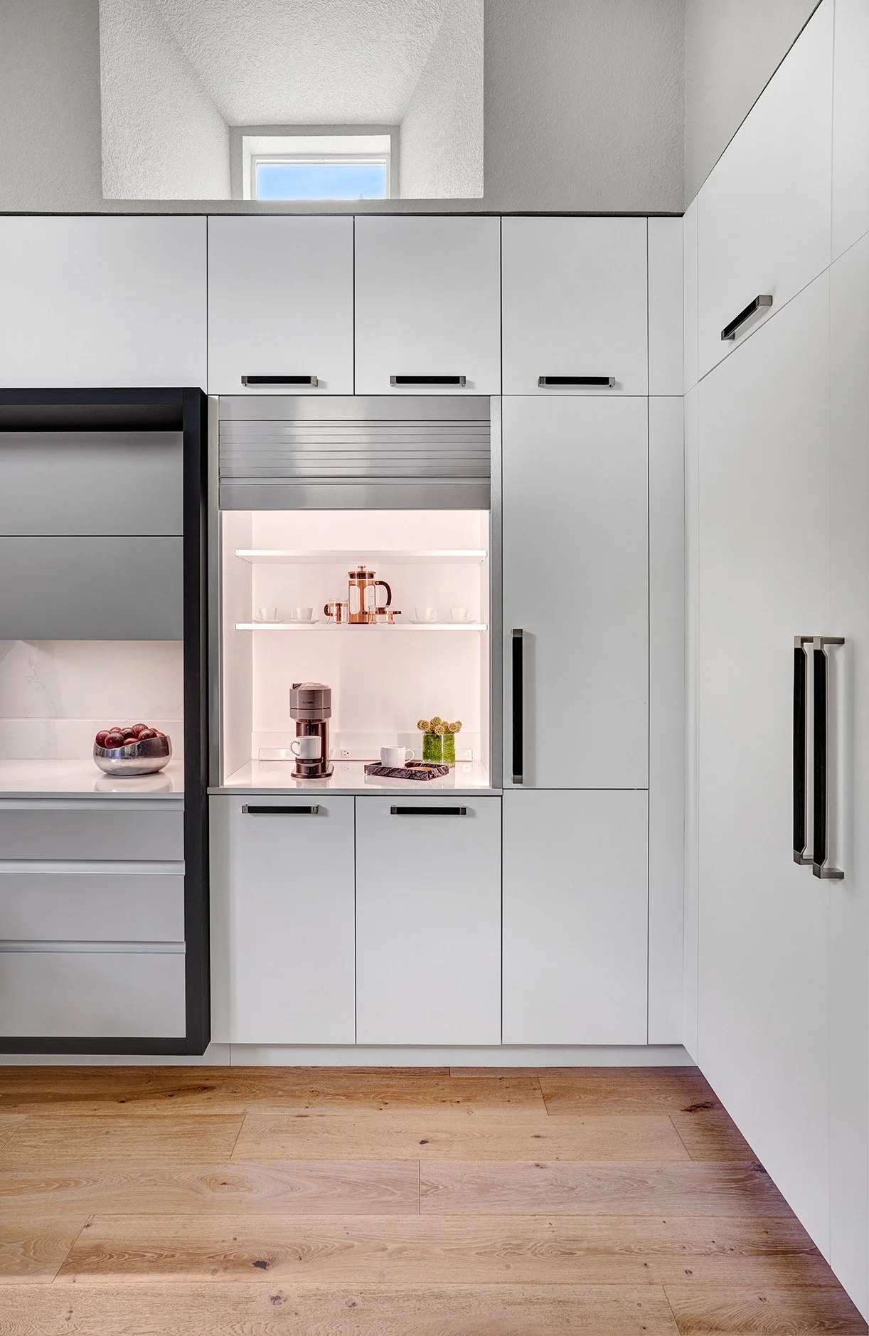 Modern kitchen remodel, black + white, large island, European cabinetry, appliance garage