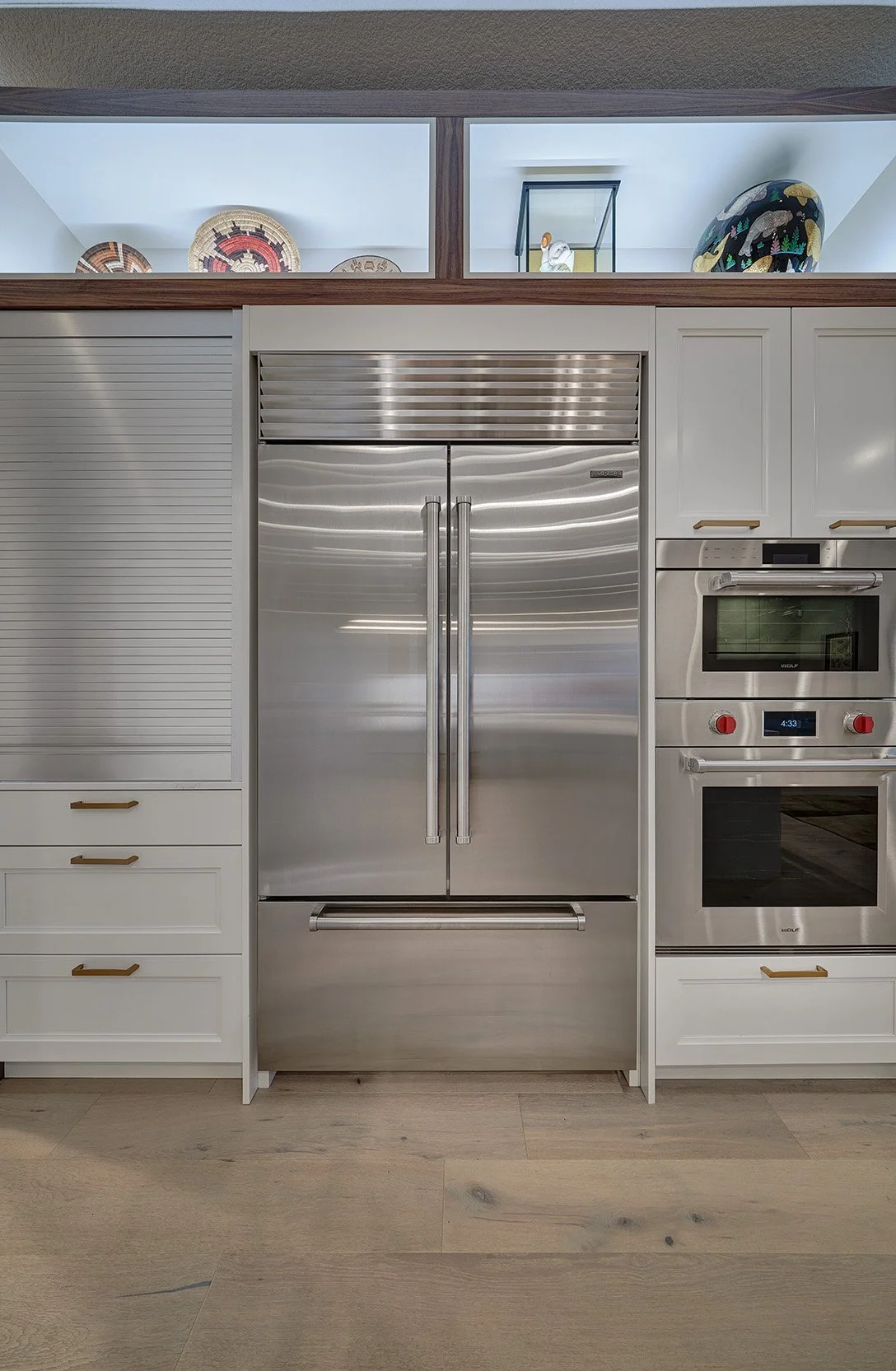 Modern kitchen remodel, white + walnut cabinetry, tall appliance wall, art display