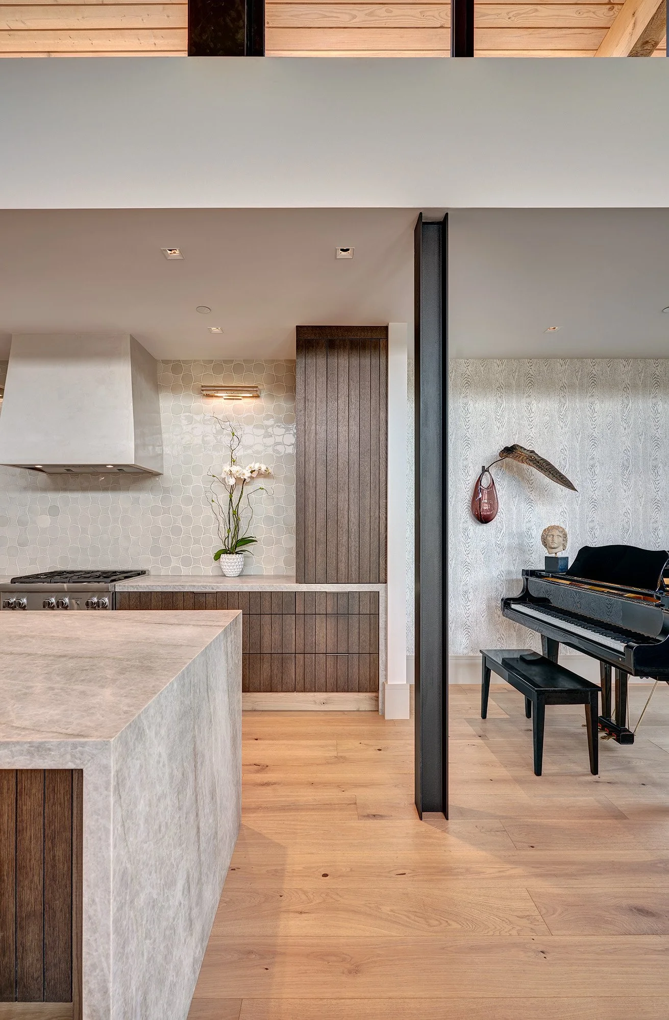 Warm contemporary new construction home, kerf cut kitchen cabinet, waterfall stone island, hidden storage counterwall
