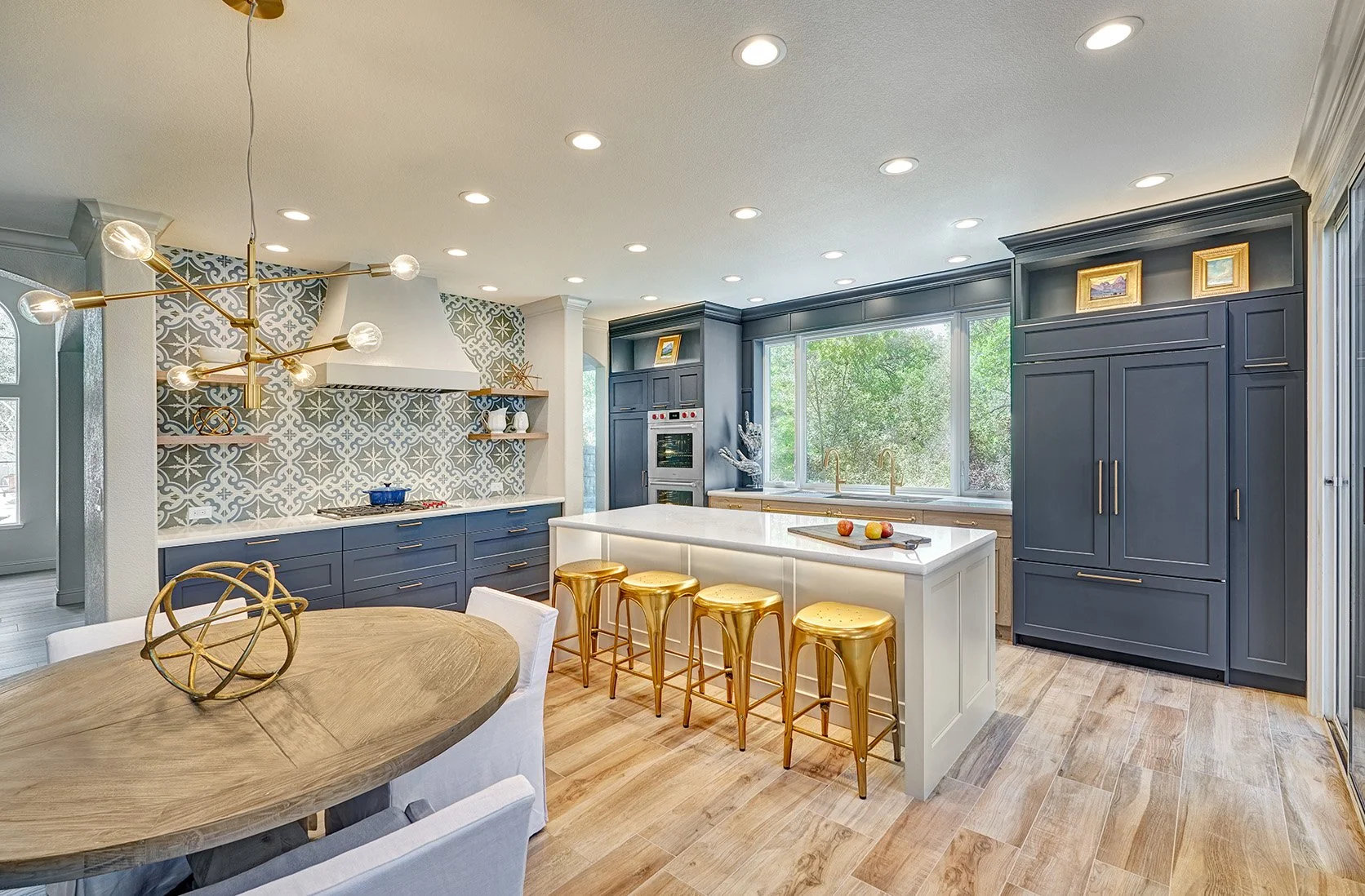 Modern Spanish colonial style kitchen remodel, blue, white + wood cabinetry, large seating island, patterned tile splash