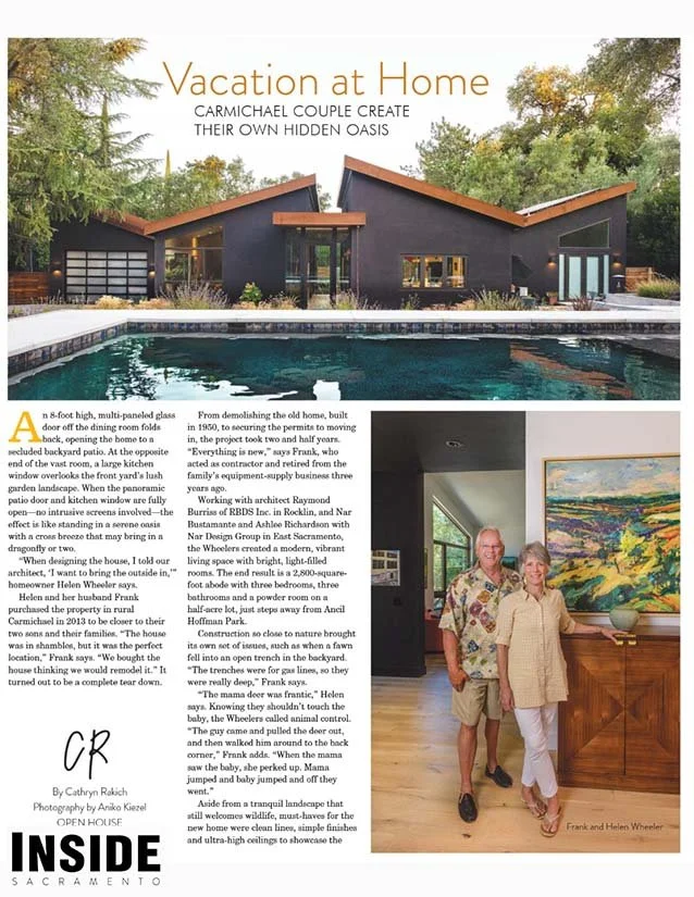 A magazine page with the headline 'Vacation at Home' showing a modern house with a several gabled roof, a swimming pool in the foreground, and lush green trees in the background. The page includes text about the house's design and features, and a pho