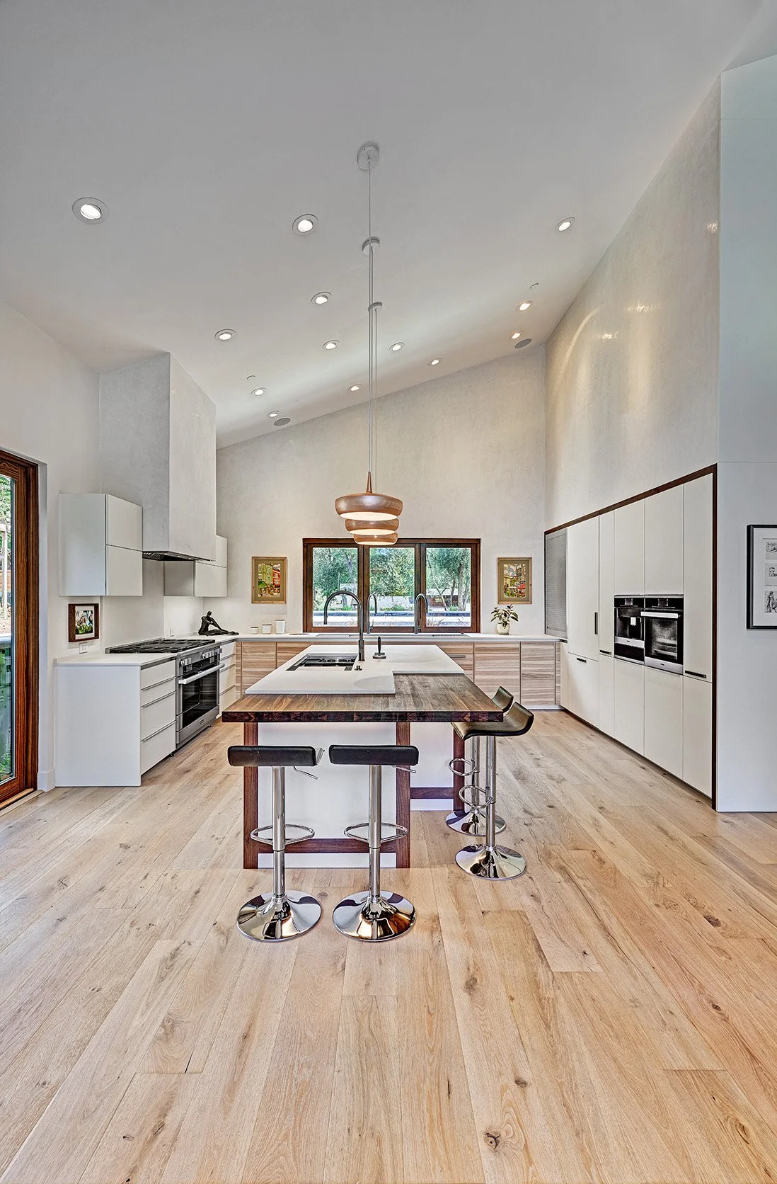 Modern home remodel, vaulted kitchen, wood wrapped appliance wall, seating island