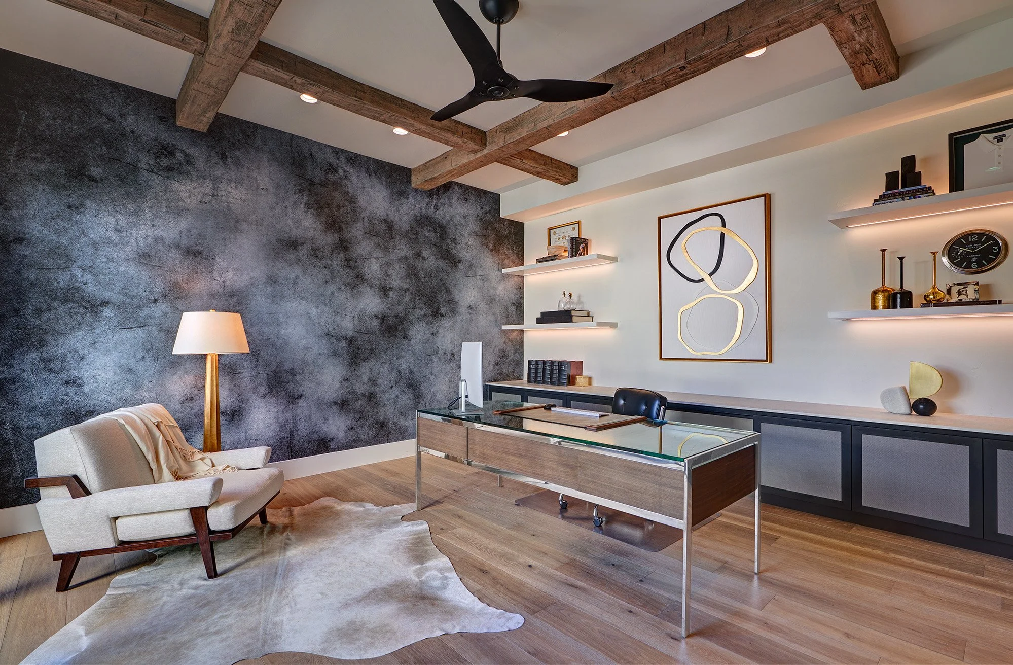 Modern new construction home, office with desk and built in cabinetry, lit floating cabinet shelves