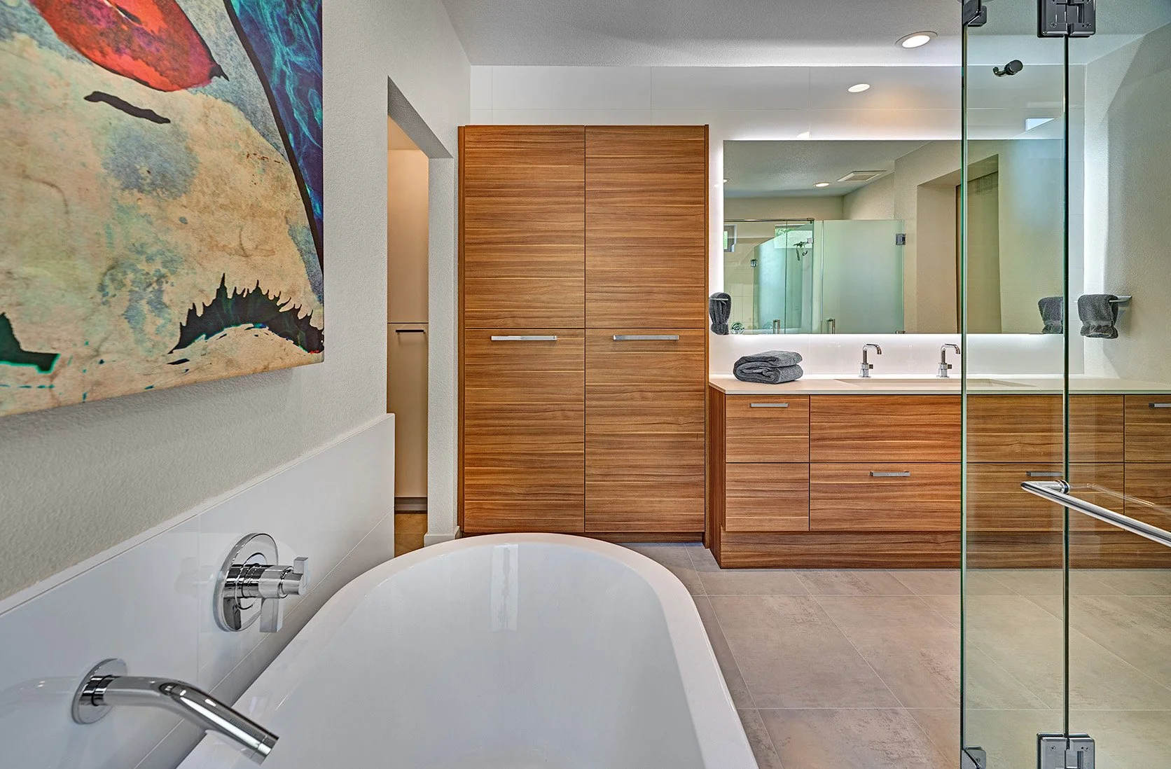 Modern primary bath remodel, European cabinetry, glass shower and toilet enclosures, freestanding tub