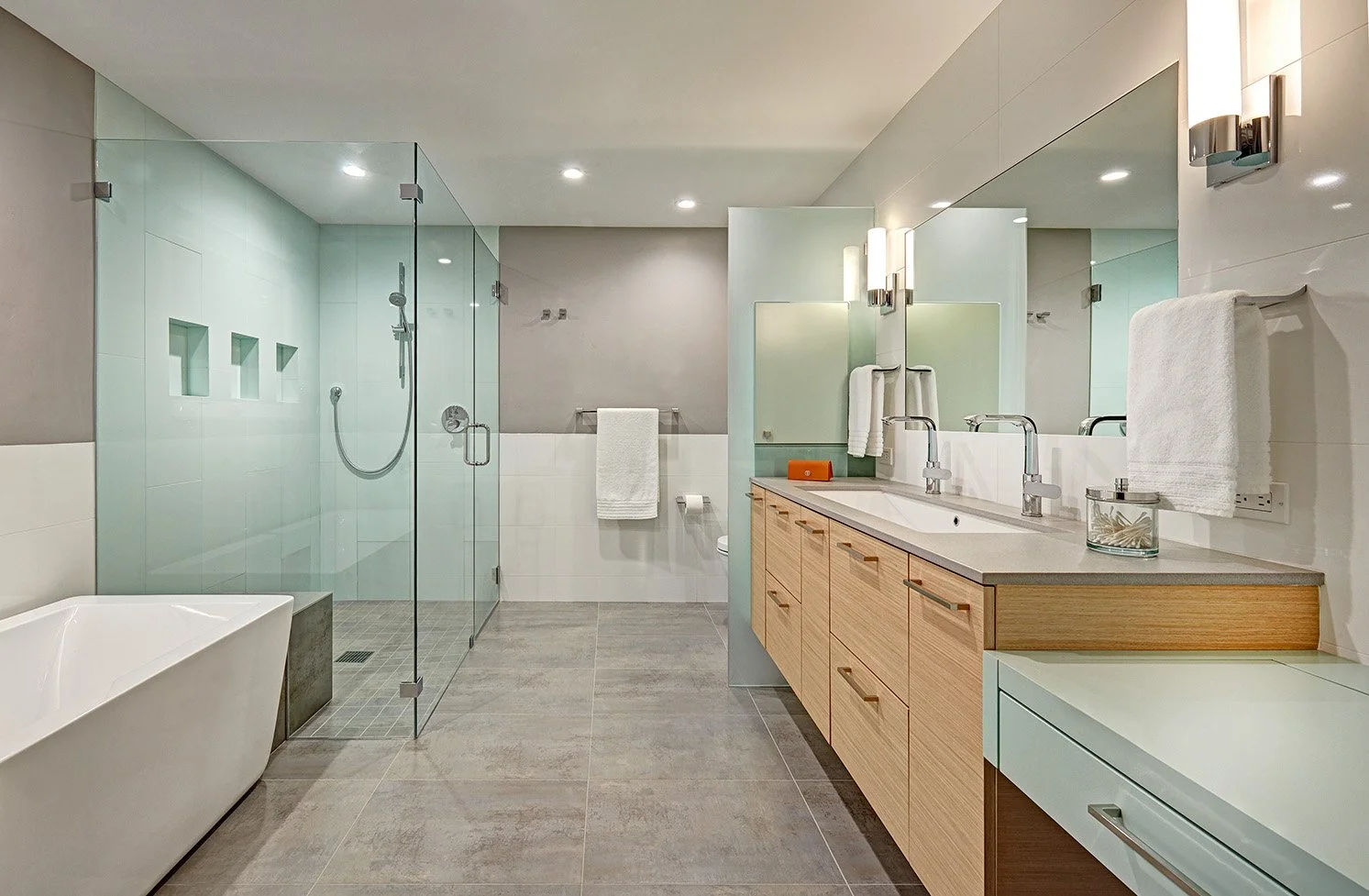 Modern primary bath remodel, laminate cabinetry, glass shower and toilet enclosures, freestanding tub