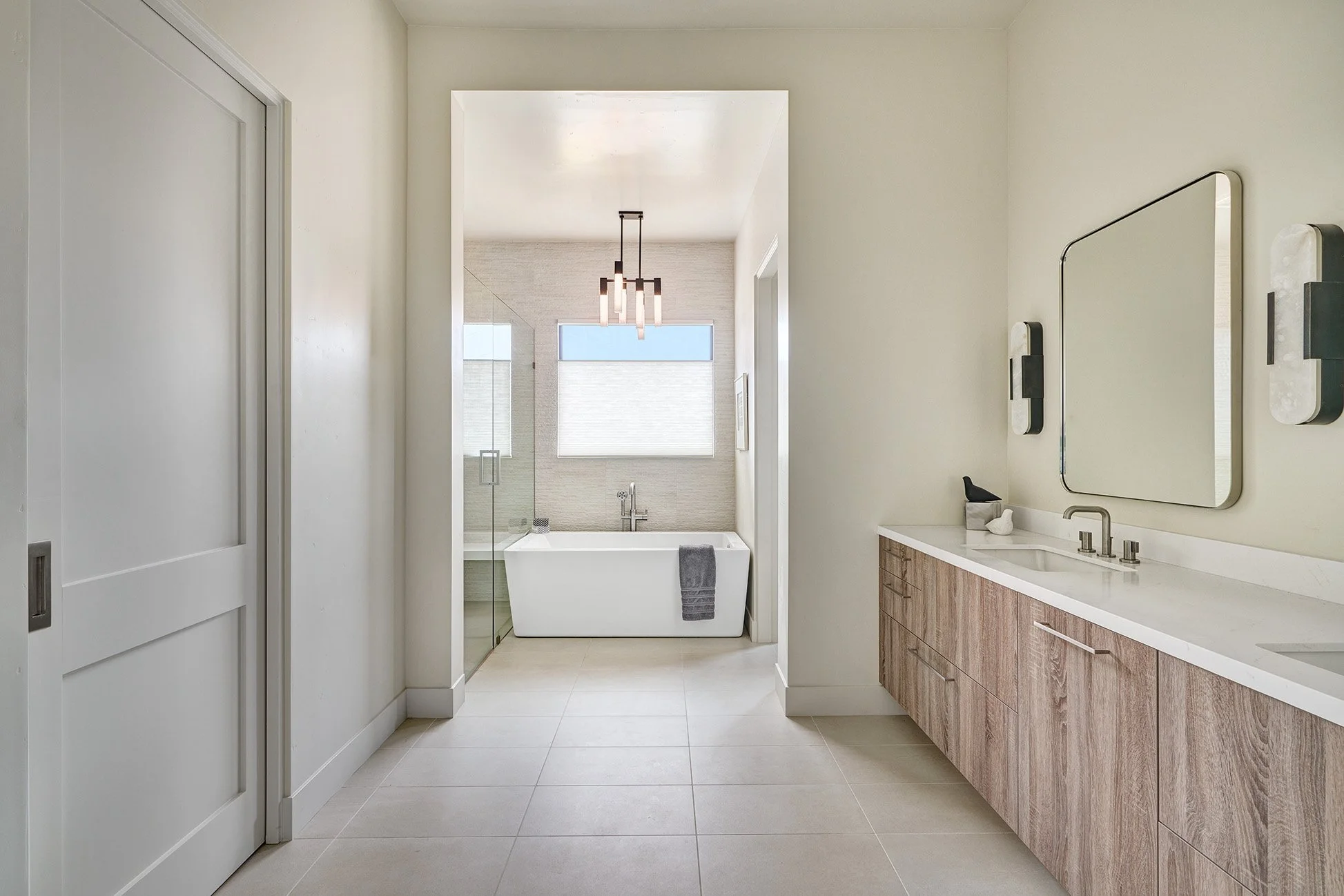 Modern new construction home, European laminate cabinetry, vanity cabinet and freestanding tub in primary bathroom