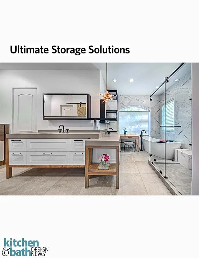 Modern bathroom with a large vanity, mirror, a small table with flowers, and a walk-in shower with a bathtub.
