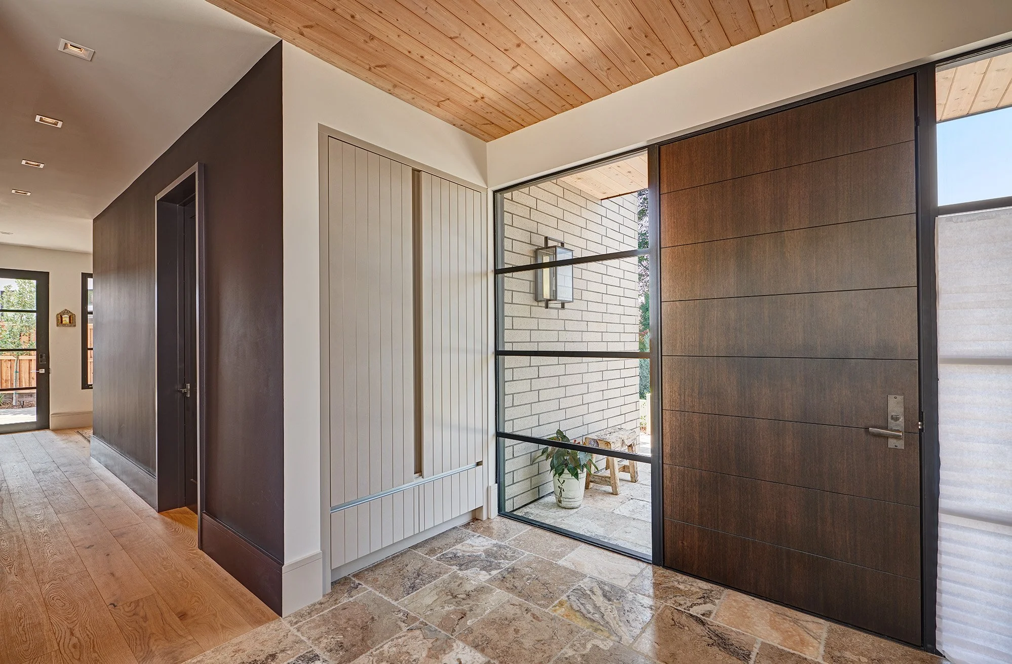 Warm contemporary new construction home, kerf cut kitchen cabinet, large entry door, inset coat closet cabinet
