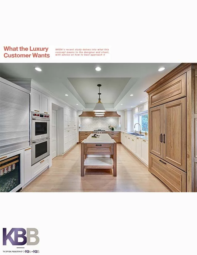 Modern kitchen with wooden and white cabinetry, central kitchen island, stainless steel appliances, and a window with a view outside.